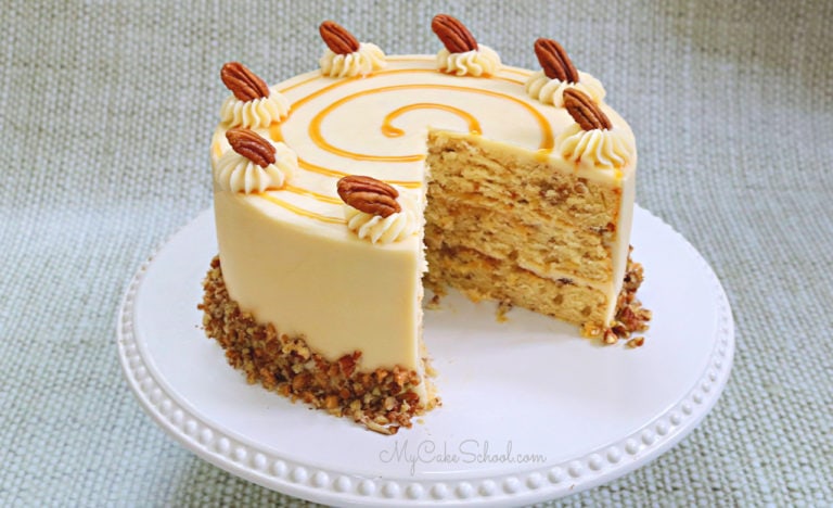Toffee Pecan Caramel Cake on white pedestal