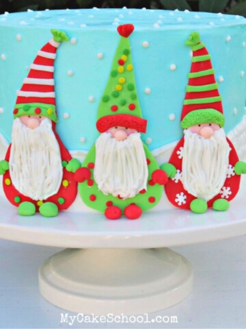 Gnome cake on a white pedestal.