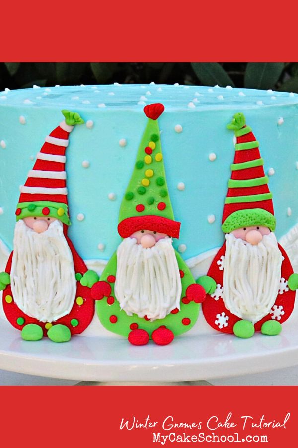 winter gnome cake- blue buttercream cake with three flat fondant gnomes across the front.