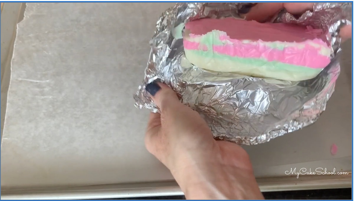 Peeling foil from striped chocolate block after removing from loaf pan