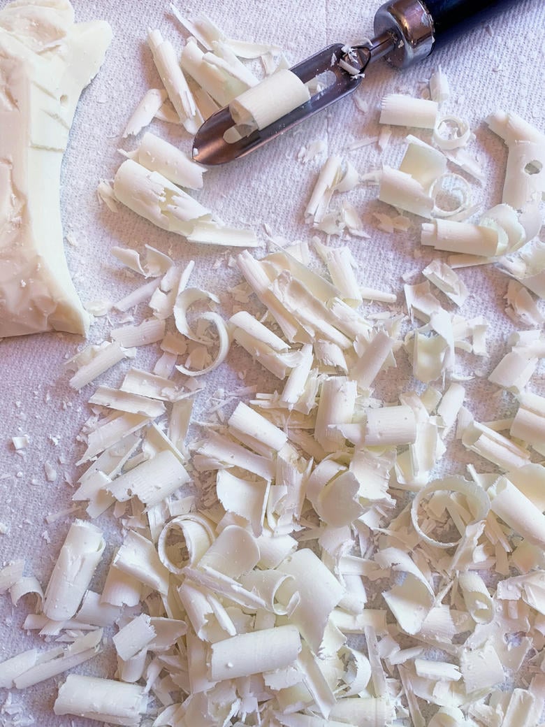 White Chocolate Curls pictured with a vegetable peeler