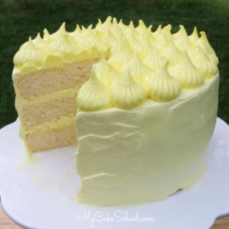 Lemon Sour Cream Cake, sliced, on a cake pedestal.