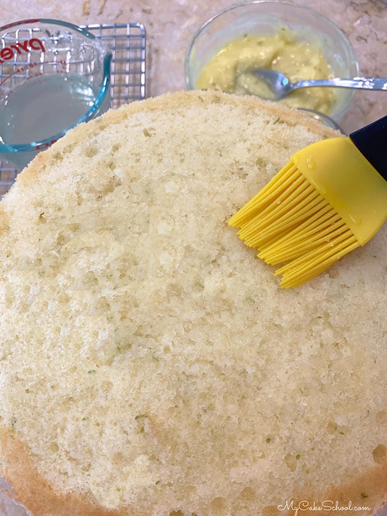 Coconut Lime Cake- Brushing Lime Syrup onto Cake for additional Lime Flavor!