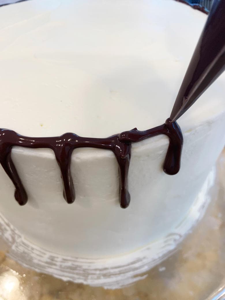 The Best Banana Split Layer Cake! The Best Banana Split Layer Cake with Whipped Cream Cheese Filling, strawberries, pineapple, and chocolate drip!
