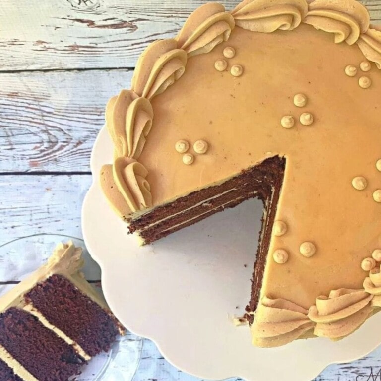 Chocolate Kahlua Cake, sliced, on pedestal.