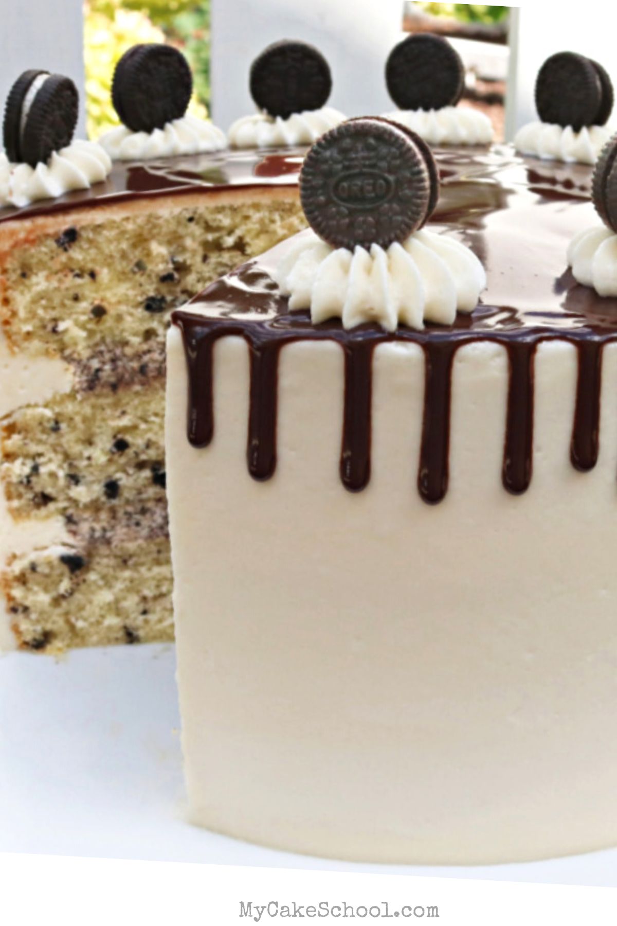Cookies and Cream Cake, sliced, on a pedestal.