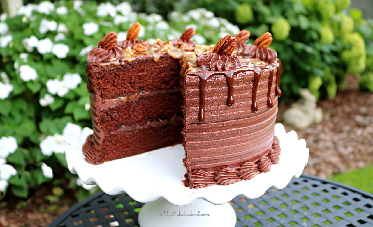 Decadent Chocolate Turtle Cake homemade chocolate cake layers, caramel sauce, ganache, toasted pecans, and frosted in chocolate buttercream. This Chocolate Turtle Cake Recipe is the BEST! So decadent and delicious!
