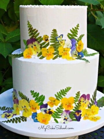 Pressed Flowers Cake on a cake pedestal.