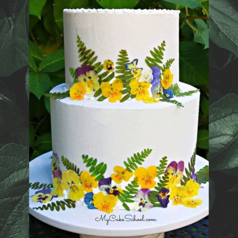 Pressed Flowers Cake on a cake pedestal.