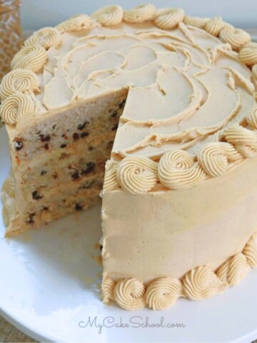 Banana Chocolate Chip Cake, sliced, on a cake pedestal.