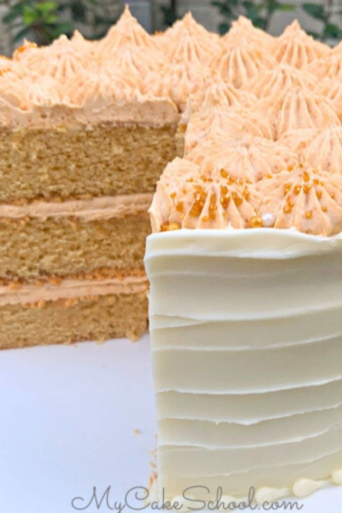 Butterscotch Cake, sliced, on a cake pedestal.