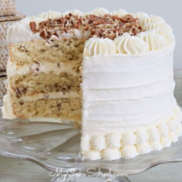 Sliced Butter Pecan Cake on glass pedestal.