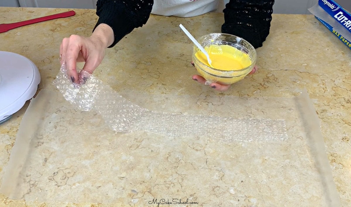 Placing Bubble Wrap, Bumpy-side-up on a sheet of waxed paper