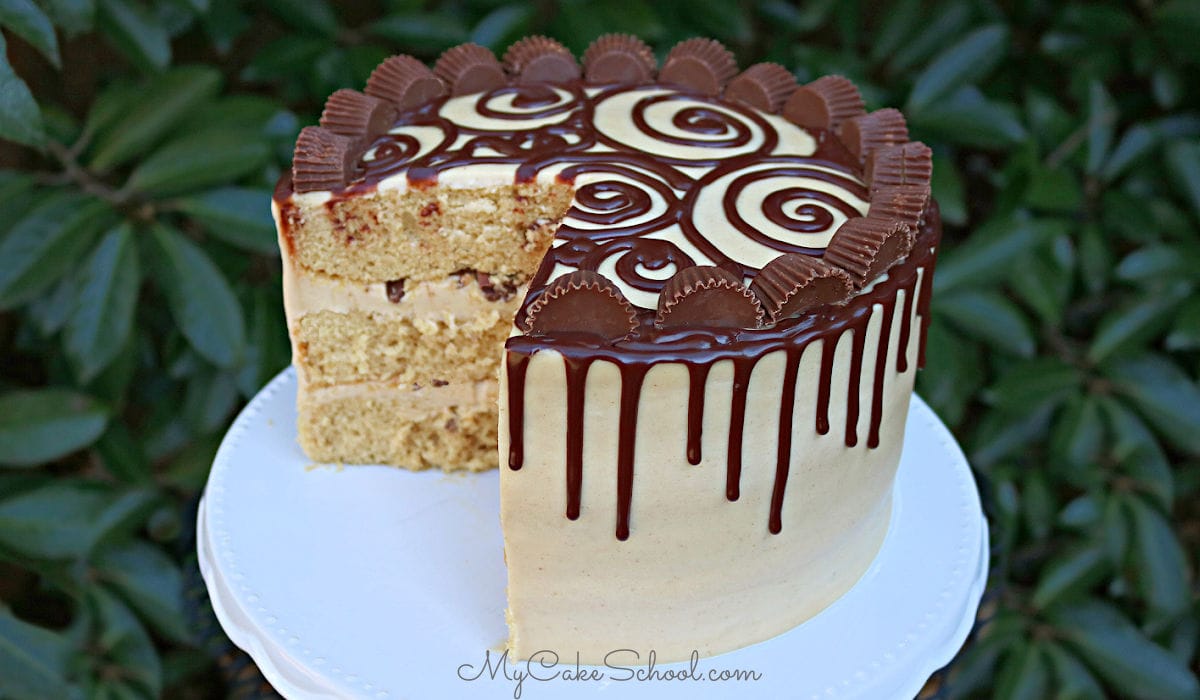 This moist Peanut Butter Cake starts with a cake mix! It is so delicious with peanut butter cream cheese frosting and a decadent ganache drip!