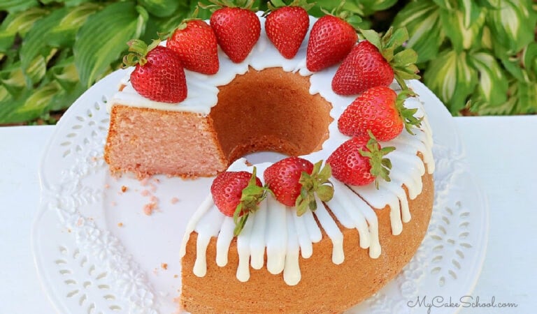Moist strawberry pound cake on glass pedestal