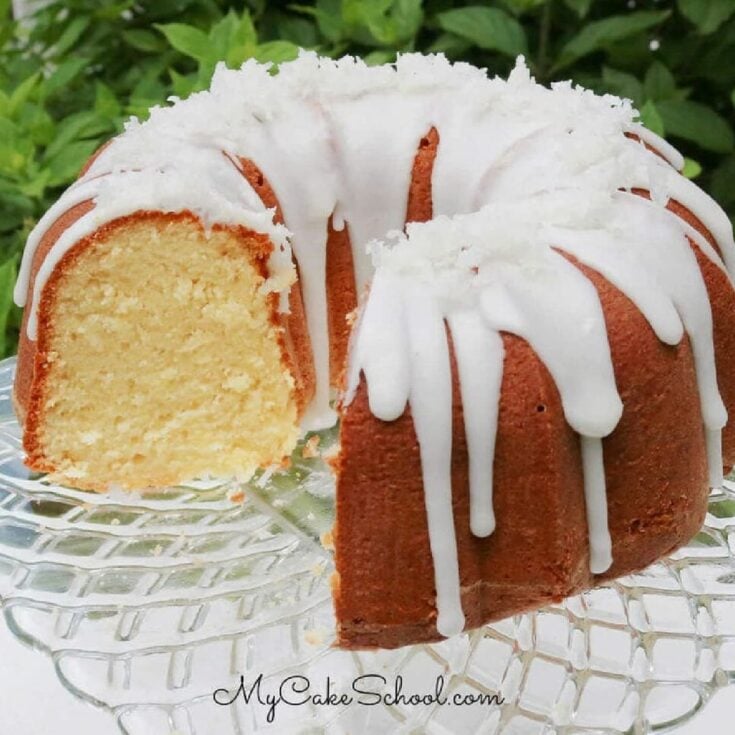 Moist coconut pound cake on a cake pedestal.