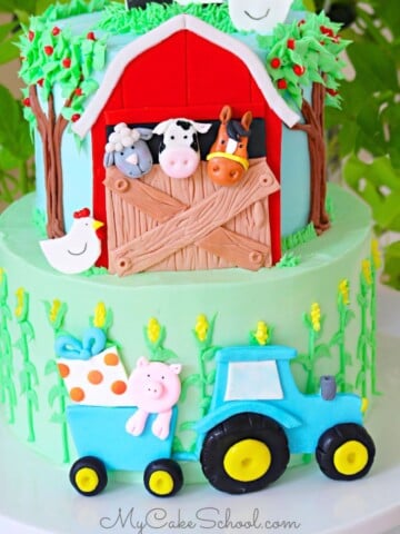 Photo of the finished two tier Farm Cake, featuring a red barn on front of top tier with animals peeking out.