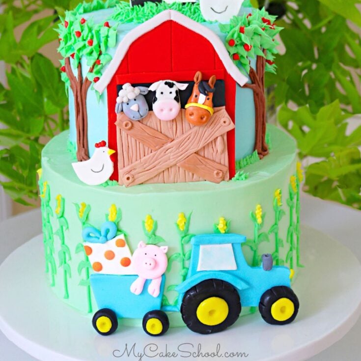 Photo of the finished two tier Farm Cake, featuring a red barn on front of top tier with animals peeking out.