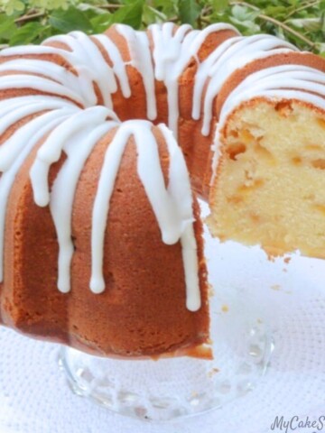 Peach Pound Cake, sliced, on a cake pedestal.