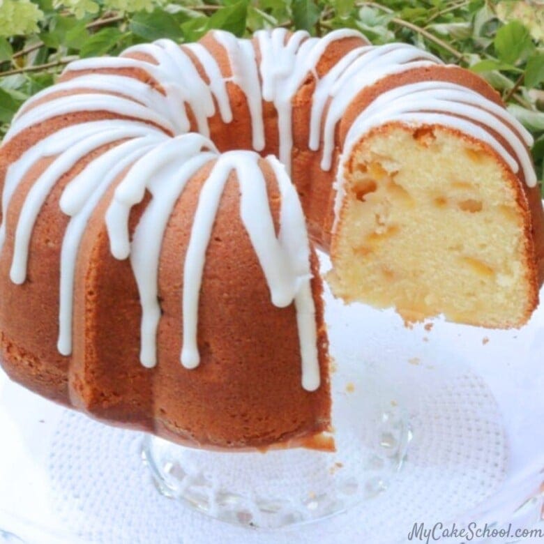 Peach Pound Cake, sliced, on a cake pedestal.