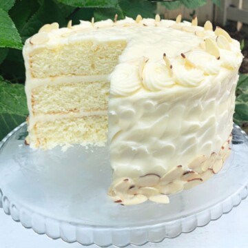 Almond Cake, sliced on a glass pedestal.