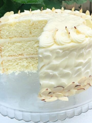 Almond Cake, sliced on a glass pedestal.