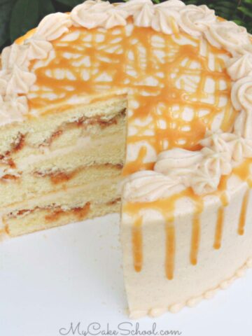 Sliced snickerdoodle cake on a white pedestal.