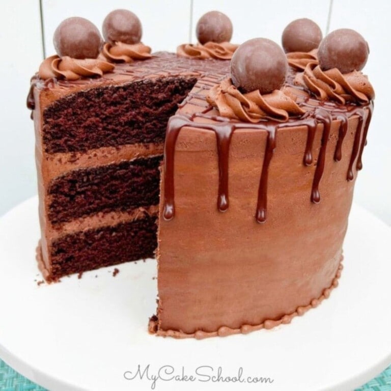 Chocolate Truffle Cake, sliced, on a pedestal.