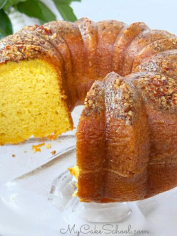 easy rum cake, sliced, on a cake pedestal.