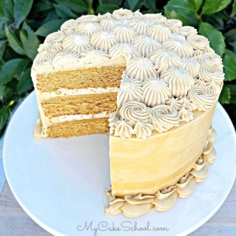 Espresso cake, sliced, on a cake pedestal.