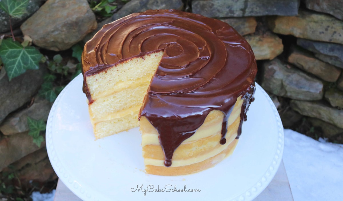 Moist Boston Cream Pie with pastry cream filling and chocolate ganache glaze! Homemade Boston Cream Pie