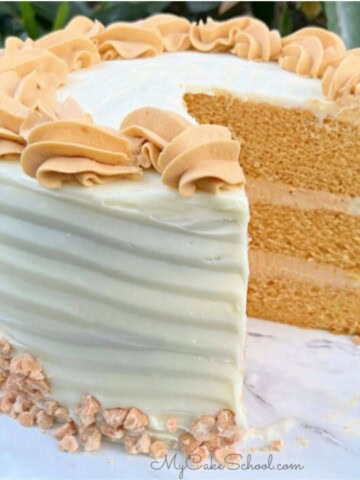 Butterscotch Cake, sliced, on a cake pedestal.