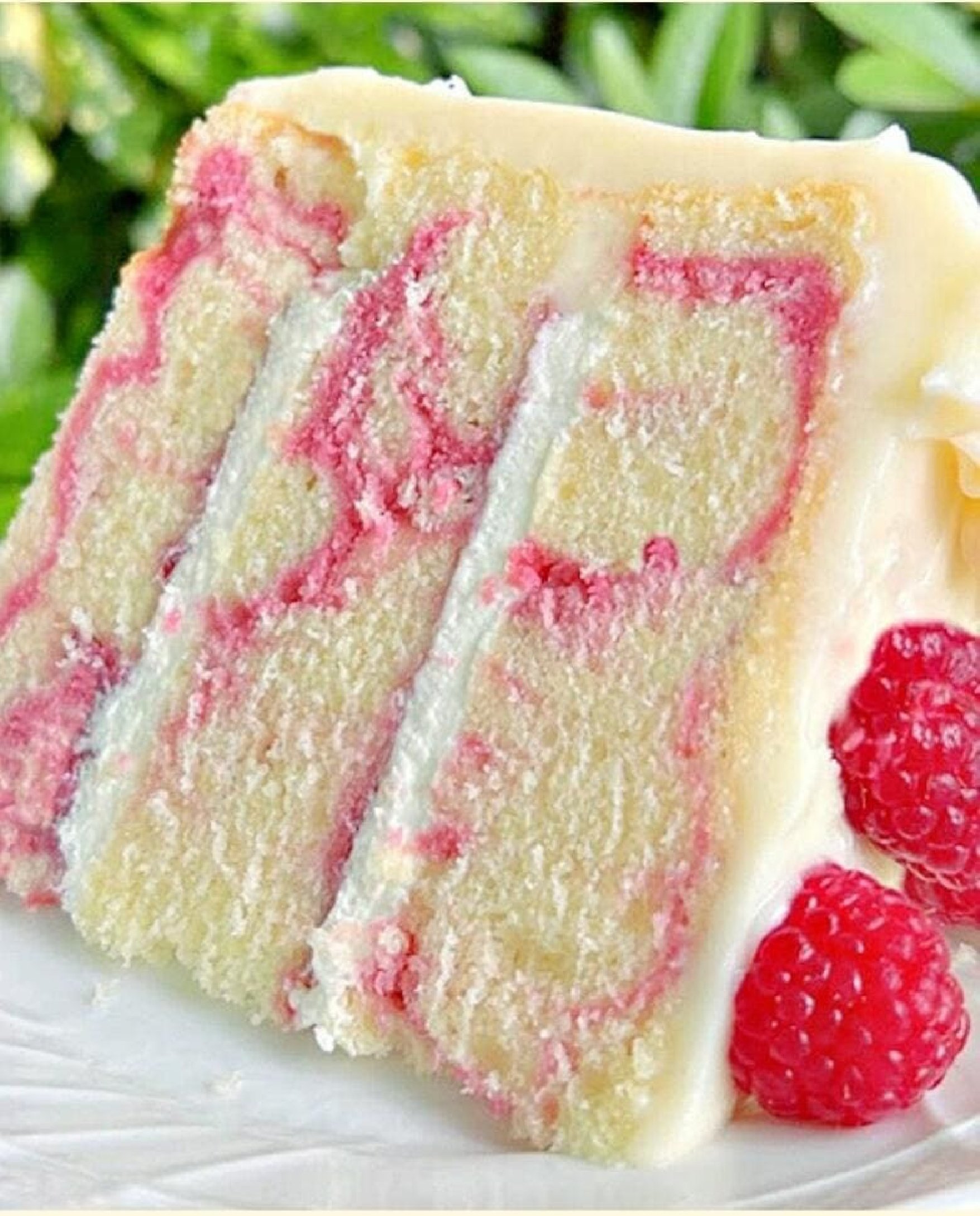 Slice of Almond Raspberry Swirl Cake on a white plate