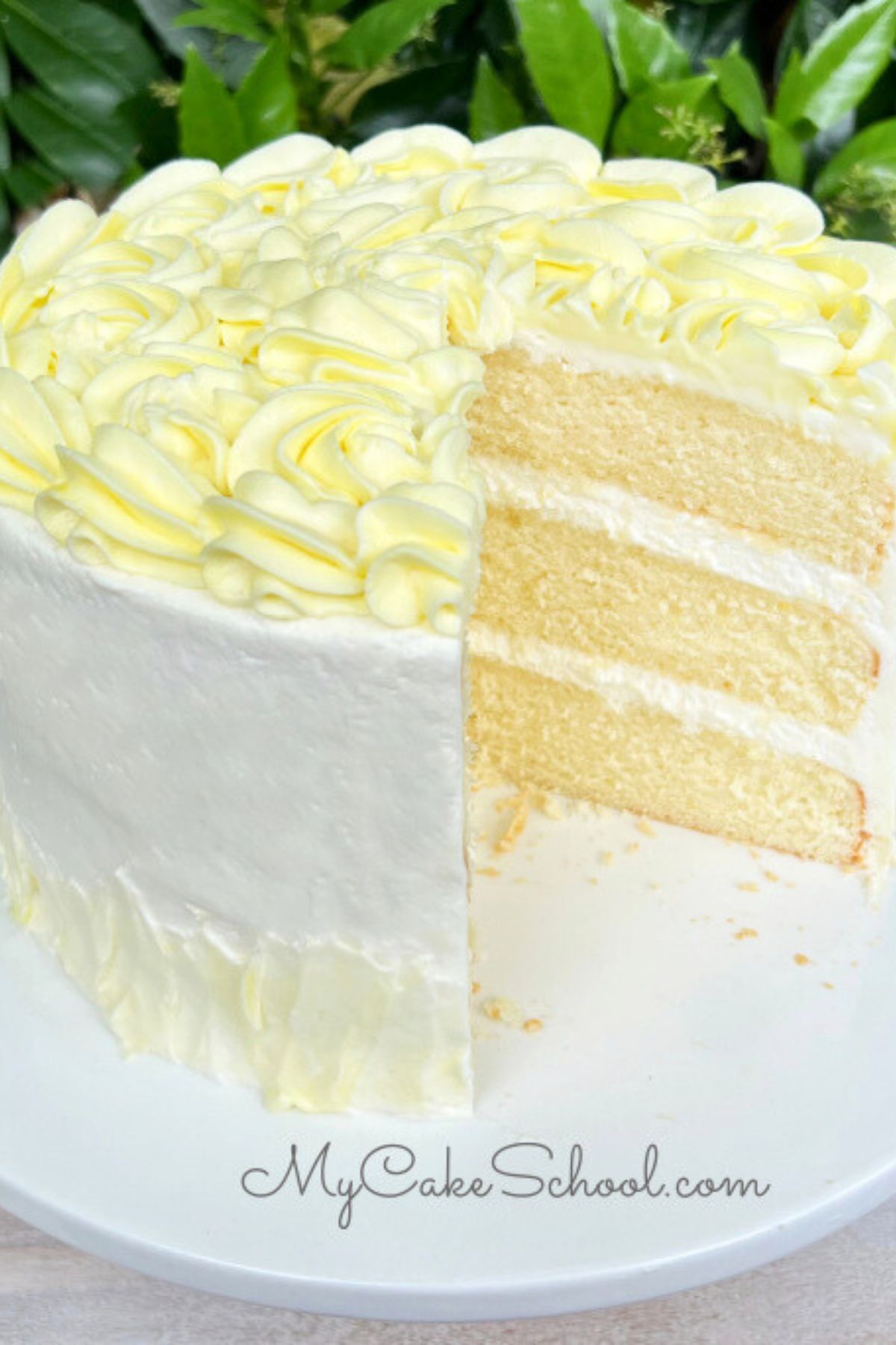 Sliced Limoncello Cake on pedestal.