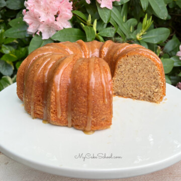 Banana Bundt Cake, sliced, on a white cake pedestal.