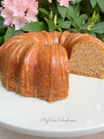 Banana Bundt Cake, sliced, on a white cake pedestal.