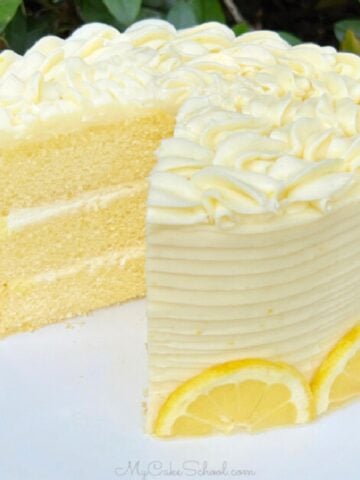 Sliced Lemon Mascarpone Cake on a white cake pedestal.