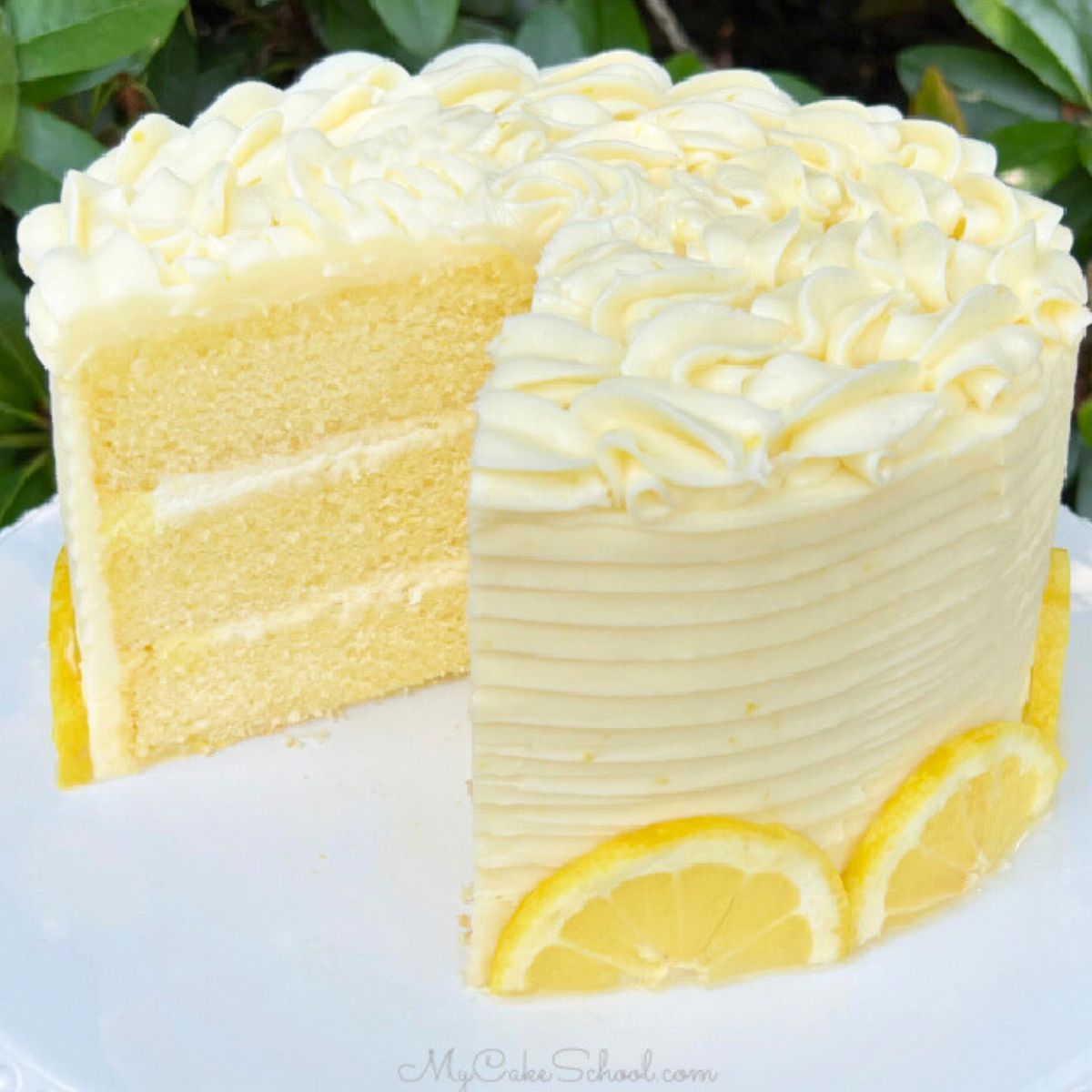 Sliced Lemon Mascarpone Cake on a white cake pedestal.
