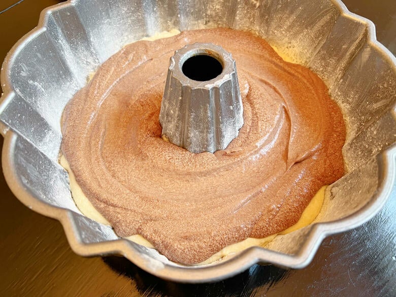 Layering Vanilla and Chocolate Batter in pan for Marble Cake