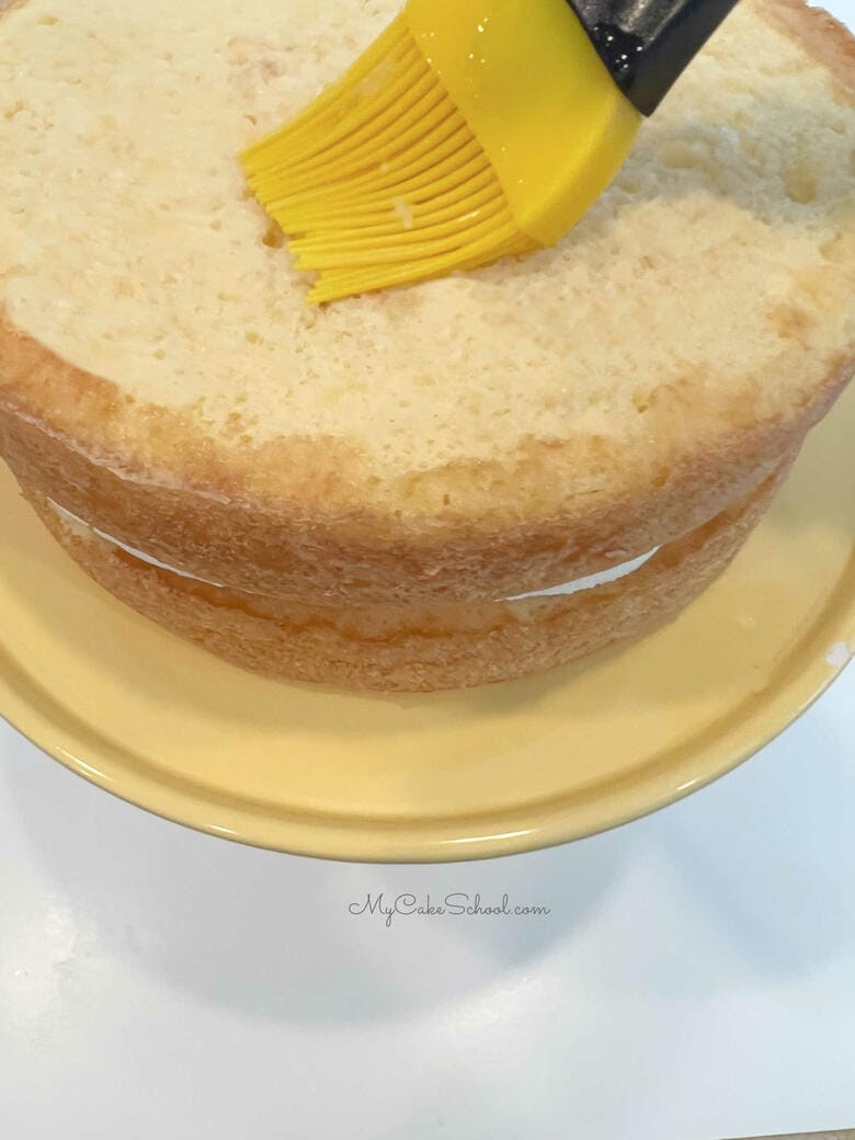 Brush cake layer with pineapple juice