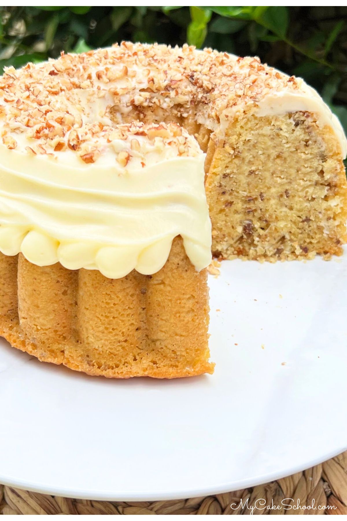 Sliced Italian Cream Bundt Cake recipe (from cake mix) on a white pedestal.