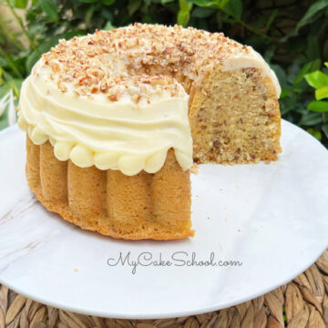 Sliced Italian Cream Bundt Cake from cake mix on a white pedestal.