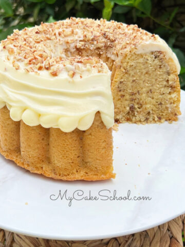 Sliced Italian Cream Bundt Cake from cake mix on a white pedestal.