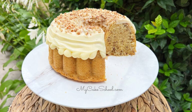 Sliced Italian Cream Bundt Cake from cake mix on a white pedestal.
