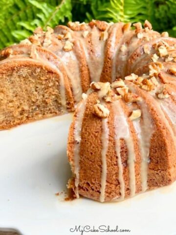 Apple Pecan Bundt Cake, sliced, on a pedestal.