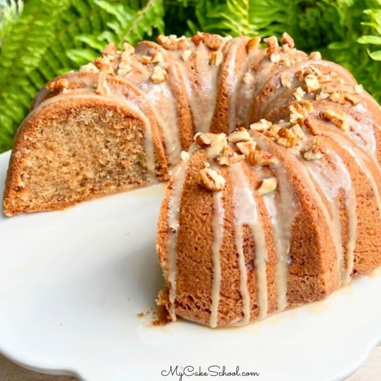 Apple Pecan Bundt Cake, sliced, on a pedestal.
