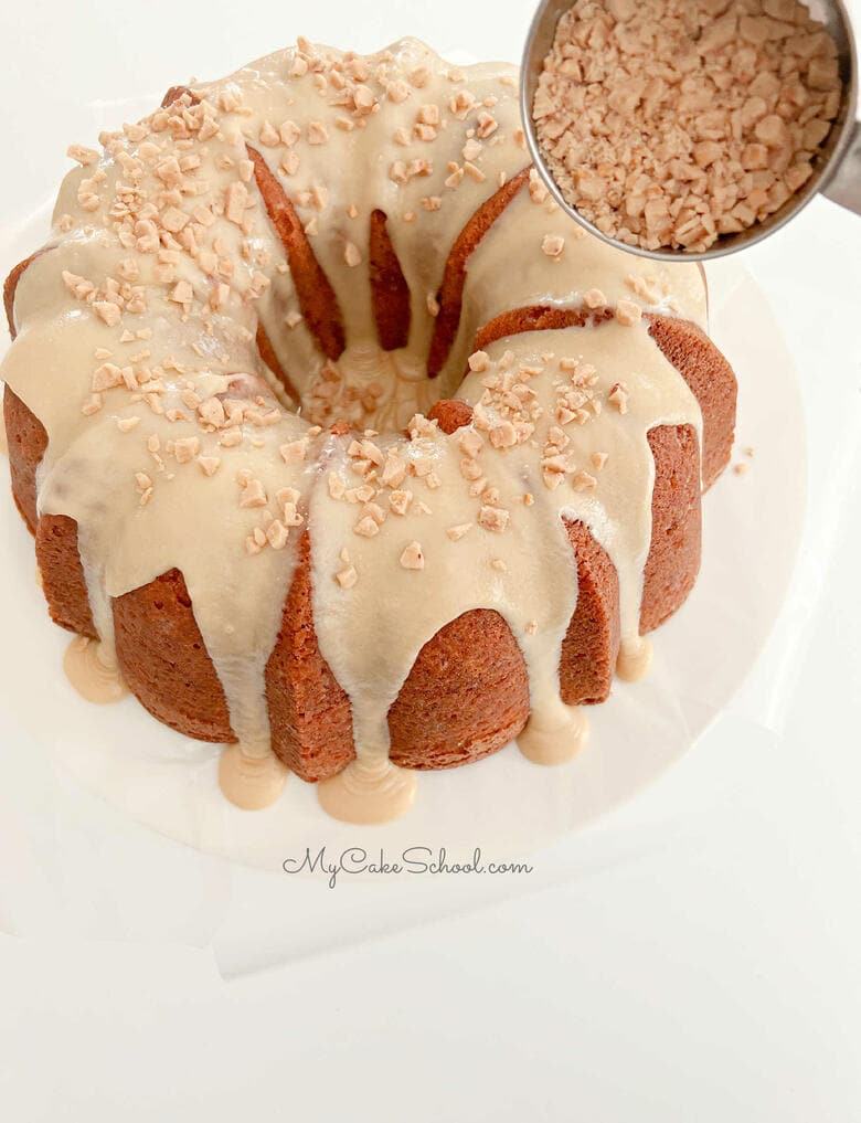 Sprinkling Toffee Bits over the Caramel Glazed Cake