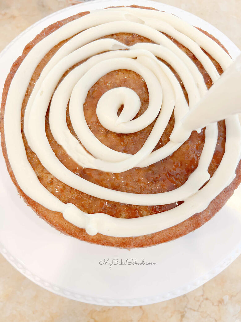 Spiral of Filling applied to the top of the cake layer with a piping bag.