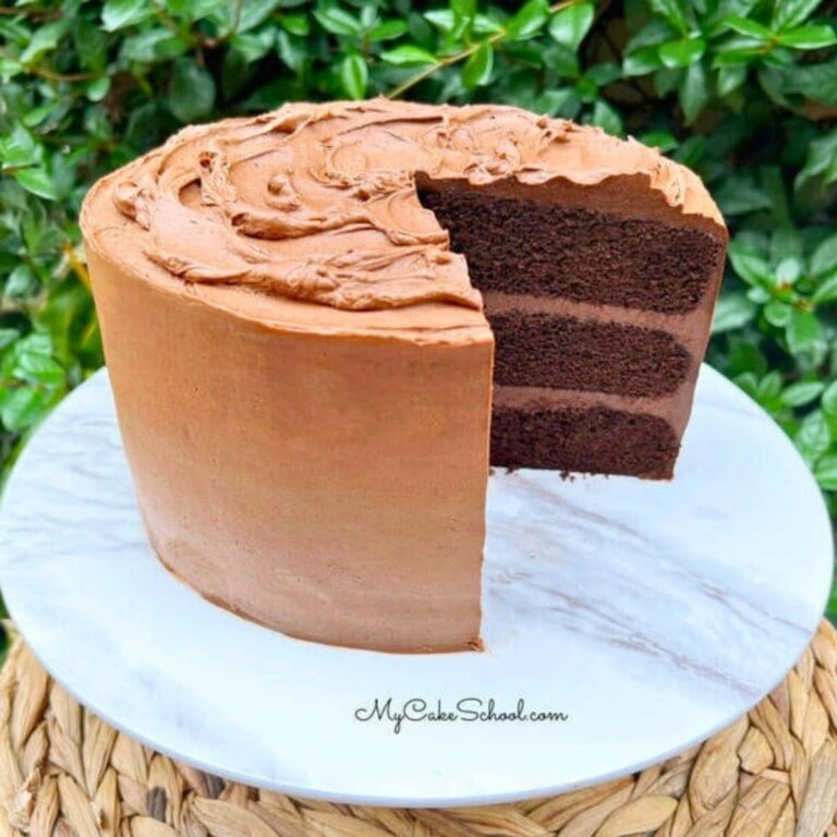 Sliced Chocolate Fudge Cake on a pedestal.