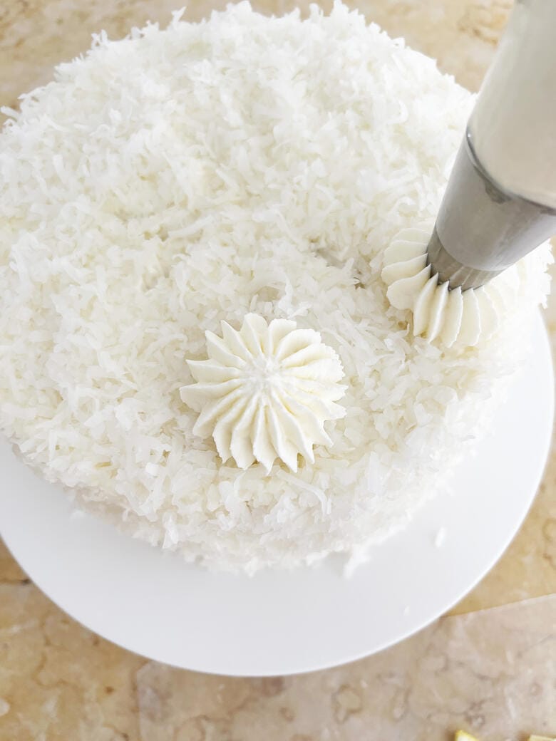 Lemon Coconut Cake-Piping Frosting Stars on Top